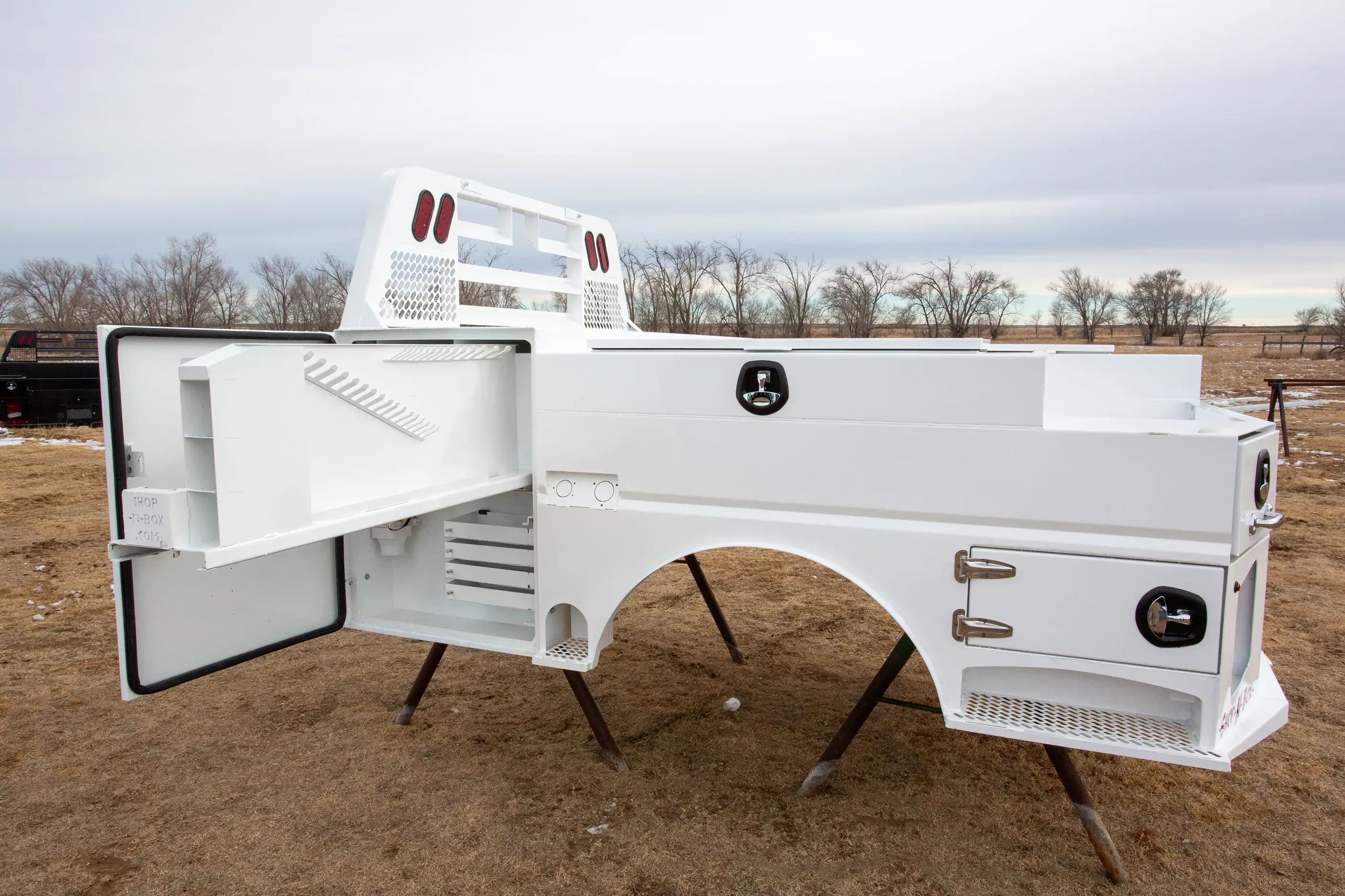 Shop-N-Box Legend Bed white finish with side compartment open showing modular inserts