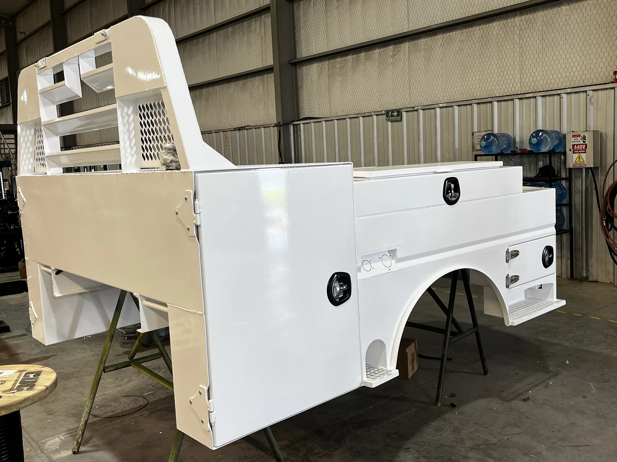 Shop-N-Box Legend Bed white finish in warehouse showing rear roll-out inserts